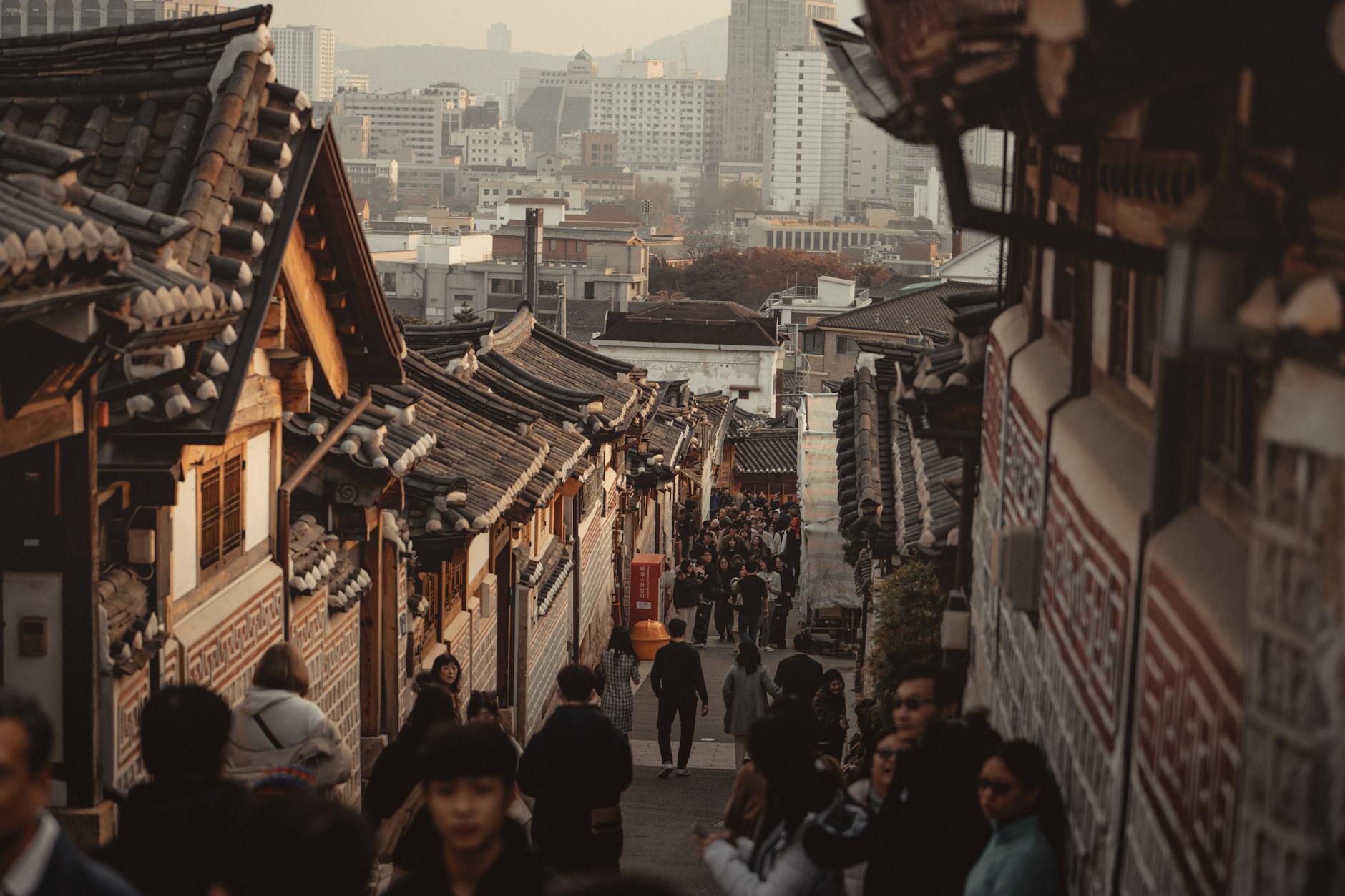 Explore Bukchon Hanok Village in Seoul, showcasing traditional Korean architecture and bustling streets.